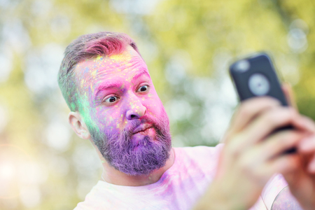 Group of friends having fun at color festivalの写真素材