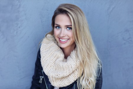 Outdoor close up portrait of young beautiful happy smiling womanの写真素材