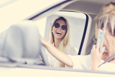 Woman talking on phone while drivingの写真素材