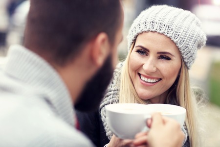 Happy adult couple dating in cafeの写真素材