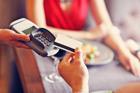 People paying in restaurant by credit card readerの写真素材