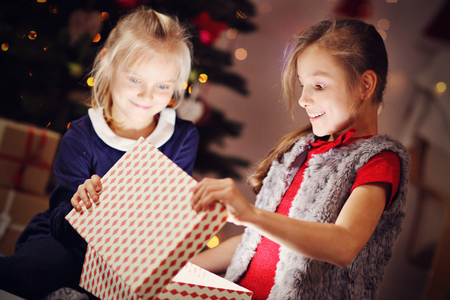 Happy Children Opening Christmas Presentの写真素材
