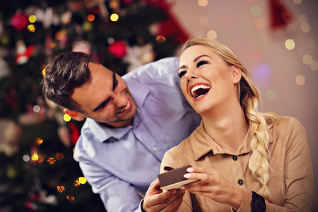 Happy Couple Opening Christmas Presentの写真素材