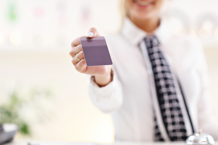 Picture showing happy receptionist working in hotelの写真素材