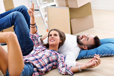 Happy adult couple moving out or in to new homeの写真素材