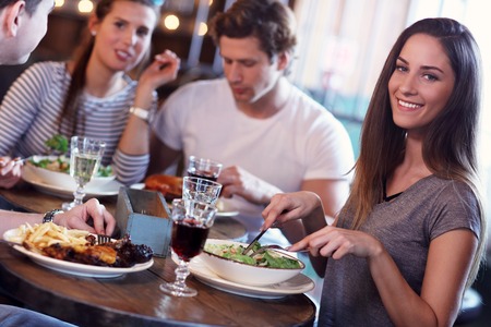 Group Of Friends Enjoying Meal In Restaurantの写真素材