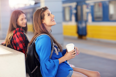 Girl friends tourists on railway platformの写真素材
