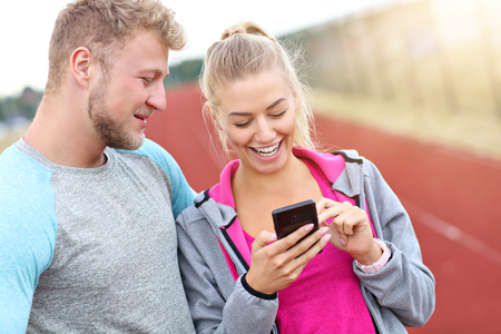 Picture showing man and woman racing on outdoor trackの写真素材