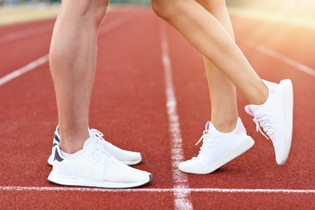 Picture showing man and woman racing on outdoor track