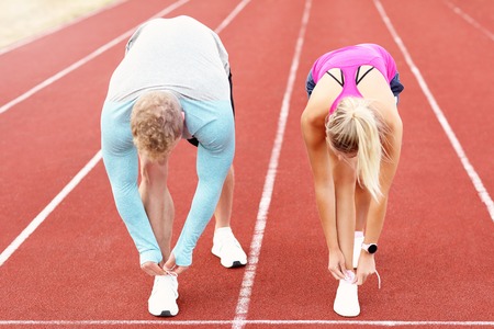 Picture showing man and woman racing on outdoor track