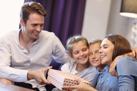 Happy family relaxing in hotel room