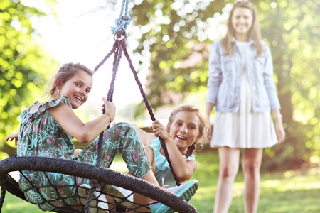 Joyful family having fun on playground