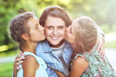 Young mom with children having fun in natureの写真素材