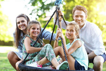 Joyful family having fun on playgroundの写真素材