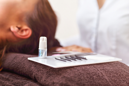 Adult woman having eyelash extension in professional beauty salonの写真素材