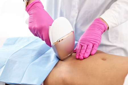 Adult woman having laser hair removal in professional beauty salonの写真素材