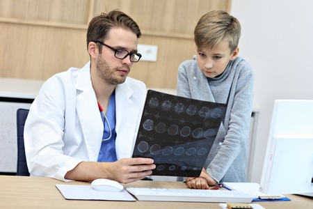 Little boy in clinic having a checkup with pediatrician