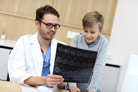Little boy in clinic having a checkup with pediatricianの写真素材