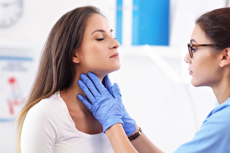 Adult woman having a visit at female doctors officeの写真素材