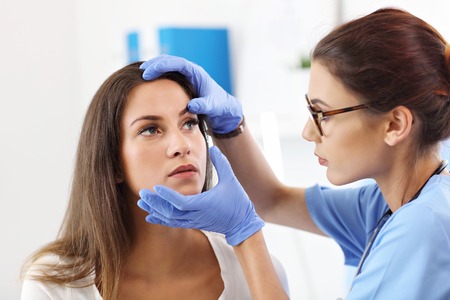 Adult woman having a visit at female oculists officeの写真素材