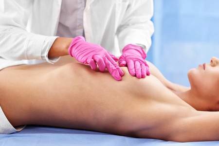 Doctor examining breastの写真素材