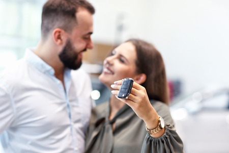 Adult couple choosing new car in showroomの写真素材