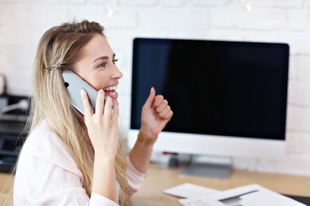 Portrait of beautiful millennial woman working in modern home officeの写真素材