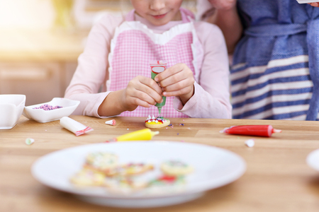 Mother and daughter preparing cookies in the kitchenの写真素材