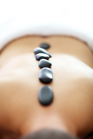 Handsome man having massage in spa salonの写真素材