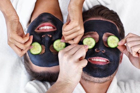 Picture of happy couple having facial in spa salon