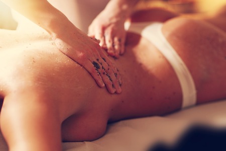Happy woman having peeling in spa salonの写真素材