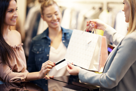 Picture of group of happy friends shopping for clothes in mallの写真素材