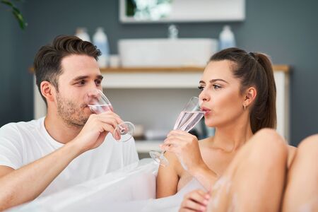 Romantic young couple enjoying and relaxing in the bathtub