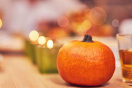 Family celebrating Thanksgiving. Focus on table and dishesの写真素材