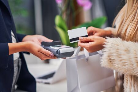 Shop assistant serving the customer in storeの写真素材