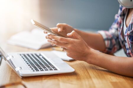Midsection of female student learning at home