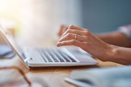 Midsection of female student learning at homeの写真素材