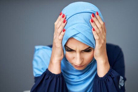 Unhappy muslim female student learning at homeの写真素材