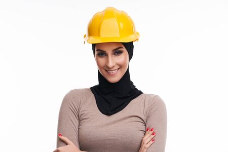 Muslim woman in helmet over white backgroundの写真素材