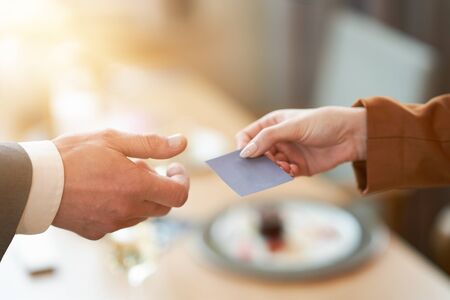 Closeup portrait of two successful business executive exchanging business cardの写真素材