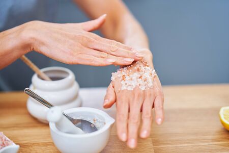 Beautiful healthy woman preparing natural cosmetics at homeの写真素材