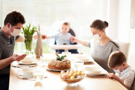 Family at home quarantine over Easter tableの写真素材