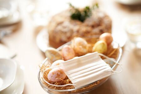 Protective mask on Easter table during coronavirus pandemic