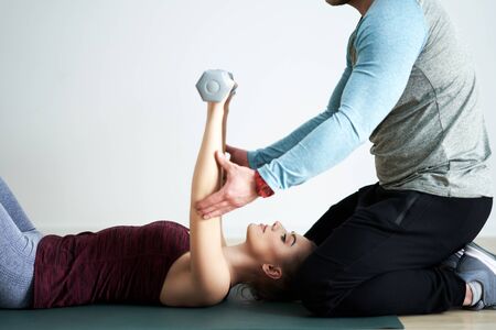 Woman with her personal fitness trainerの写真素材