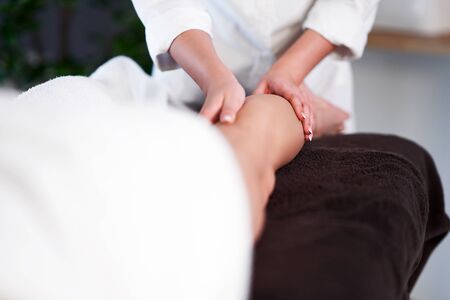 Relaxed woman receiving a leg massageの写真素材