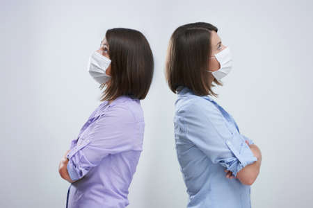 Attractive woman wearing protective mask isolated over white background