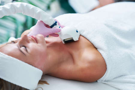 Adult woman in beauty salon undergoing face hydrogen purification