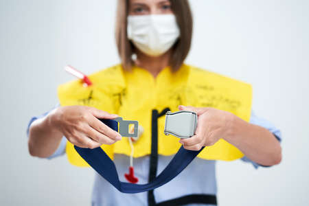 Stewardess wearing protective mask isolated over white background