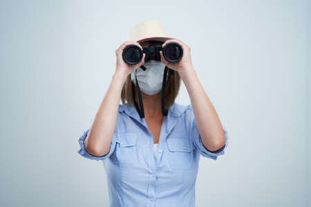 Woman tourist wearing protective mask isolated over white backgroundの写真素材