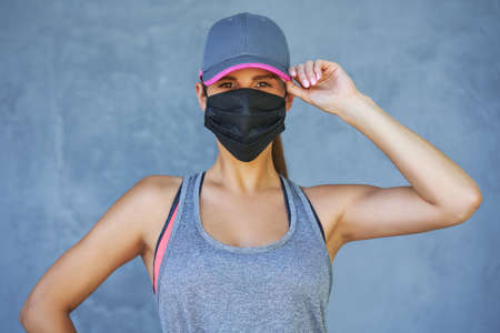 Female runner using protective mask during coronavirus pandemicの写真素材